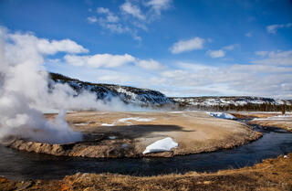 Geothermal hot spring venting steam at Black Sand Basin in winter, Yellowstone National Park, Wyoming.
