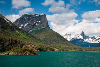 Color fine art photo of St. Mary Lake's turquoise waters below Goat Mountain and Little Chief Mountain, forested shores, Glacier National Park, Montana.