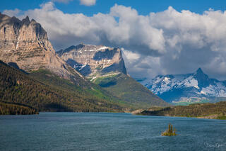 St. Mary Lake with Wild Goose Island, dramatic peaks and snow, clouds, teal blue water, Glacier National Park, fine art landscape photography by Tamara Gooch.