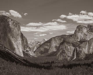 Black & white photograph of Yosemite Valley from Tunnel View showing El Capitan, Half Dome, & Bridalveil Fall. Classic fine art landscape photography print.