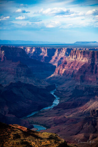 A photography print of the Grand Canyon with the Colorado river going through it.