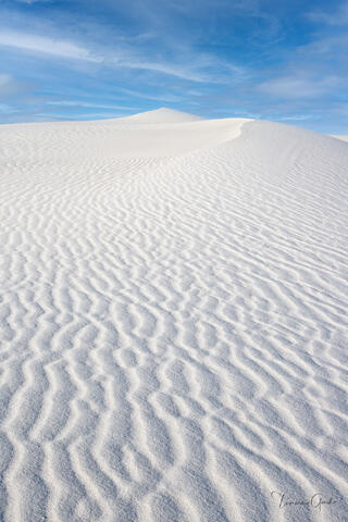 White sand dunes with wind-rippled surface patterns leading to dune peak, blue sky, White Sands National Monument fine art landscape photography by Tamara Gooch