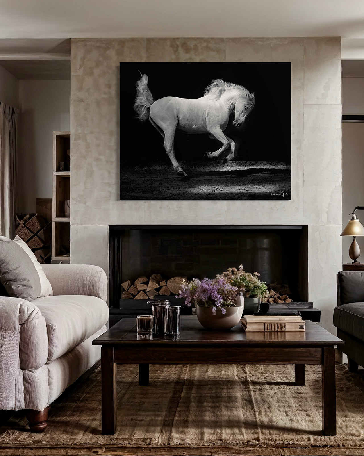 A black and white photo of a white horse against a black background as it runs free.